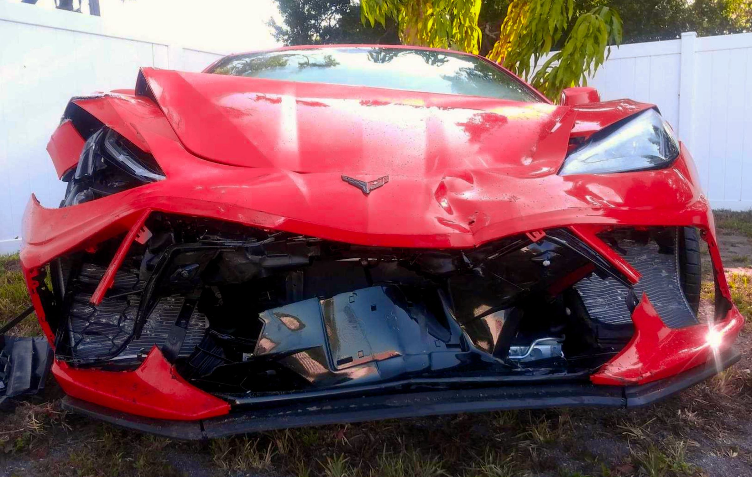 Before: crashed red corvette