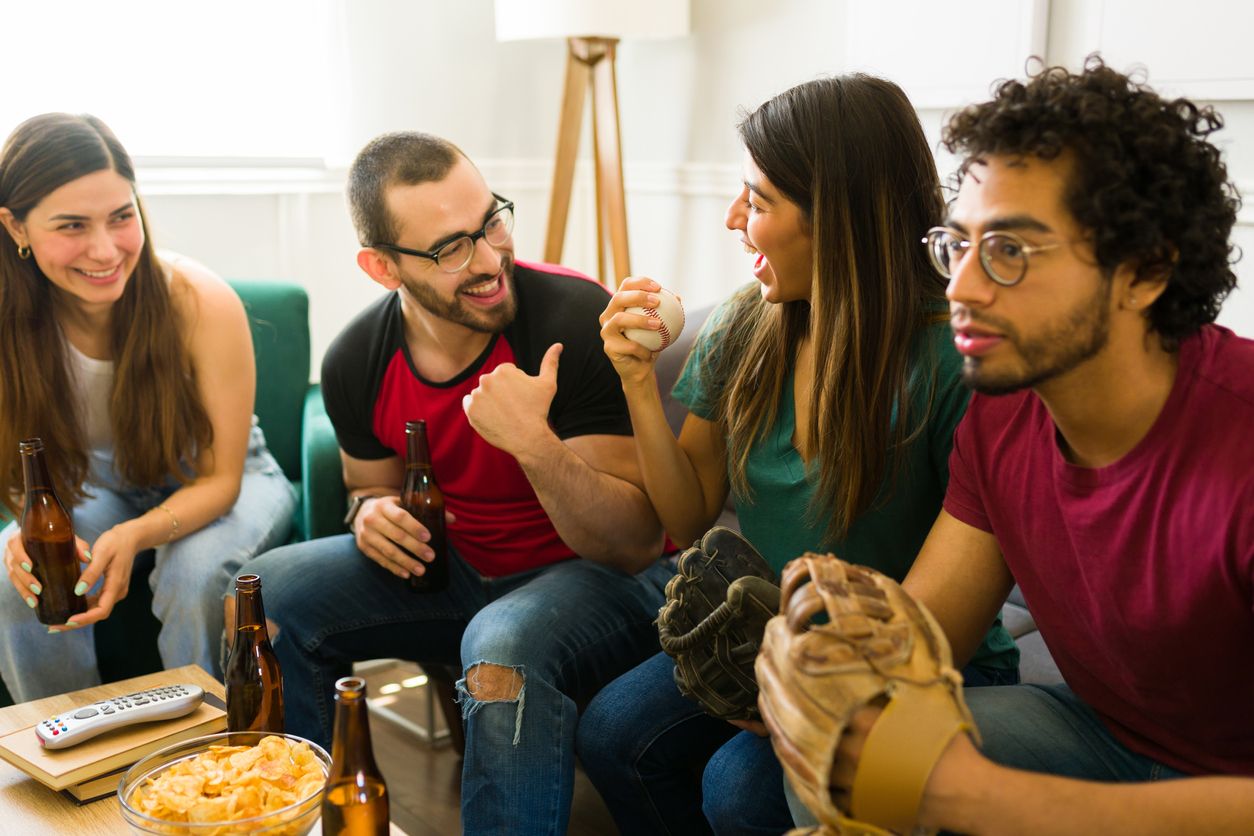 Happy friends watching baseball on TV